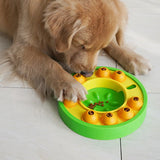 Dog using green interactive puzzle toy and slow feeder bowl.