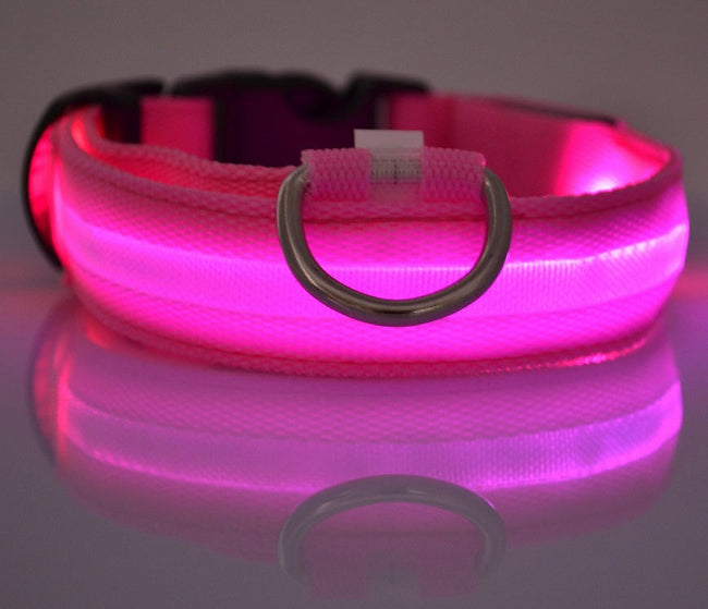 Pink nylon LED pet dog collar glowing in the dark for night safety.