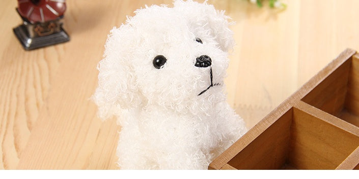 Long-haired white teddy dog plush toy pendant on wooden surface.