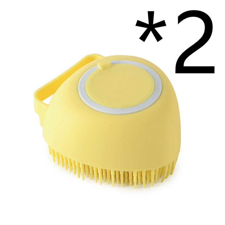 Yellow silicone dog bath massage glove brush for pet grooming and shampoo application.