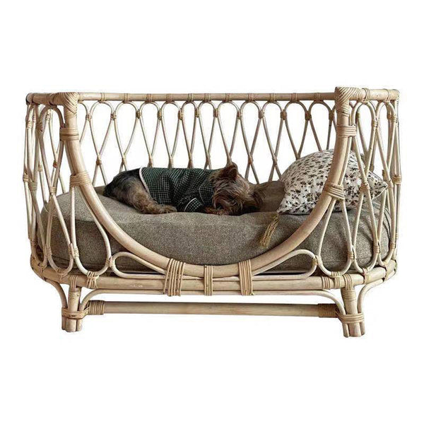 Handmade rattan pet bed with cozy cushion for dogs.