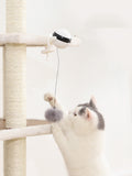 Cat playing with an electric automatic lifting motion toy with rabbit hair on a cat tree.