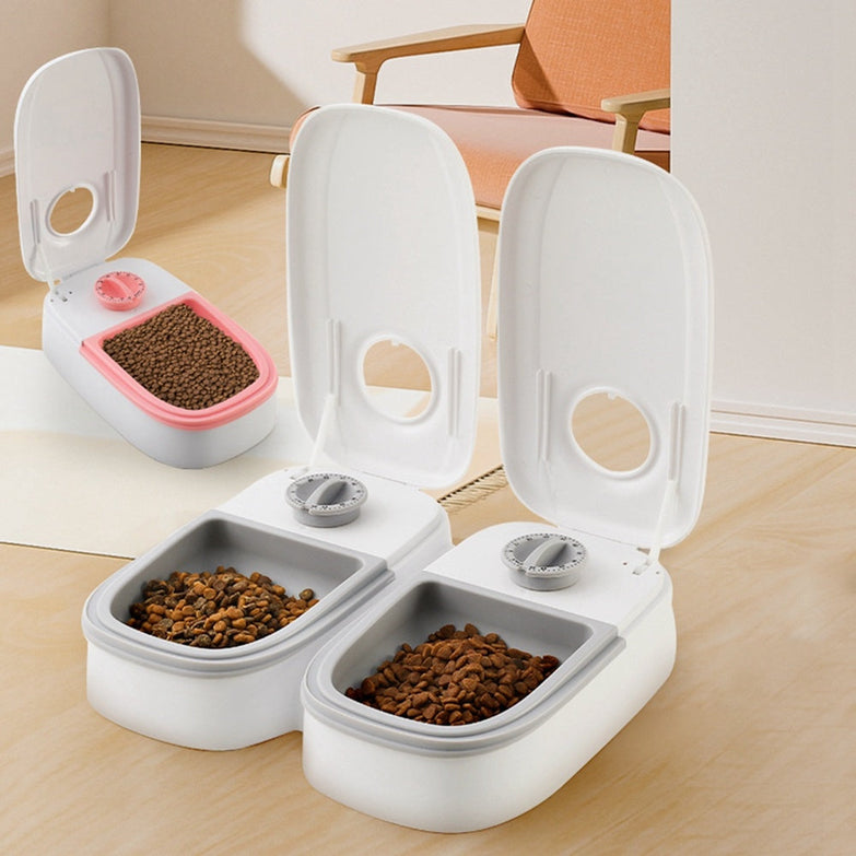 Automatic pet feeder with stainless steel bowl for cats and dogs, featuring a timer and gravity-fed food dispenser.