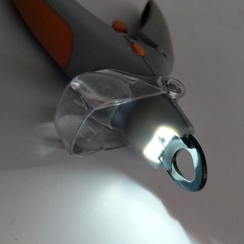 Pet nail trimmer with LED light showing cutting blade.