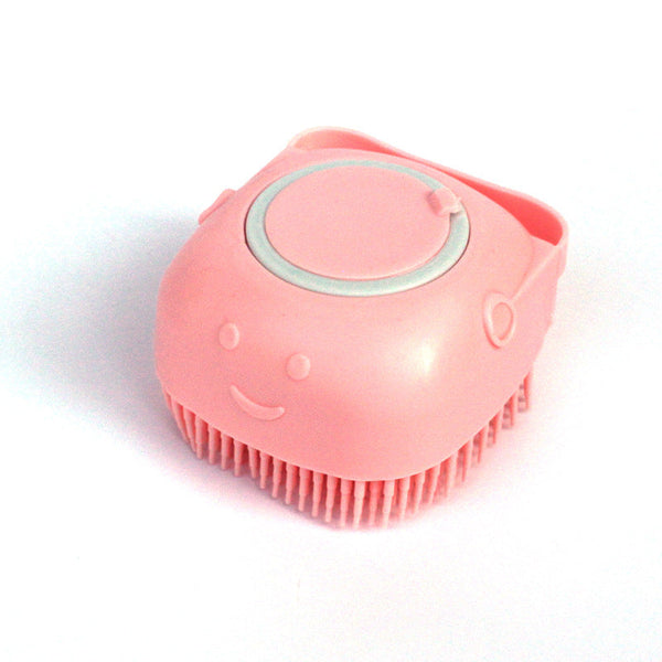 Silicone dog bath massage glove brush in pink for grooming and shampoo distribution.