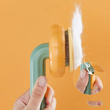 Hand-held pet cat brush with steel wire comb for hair removal.