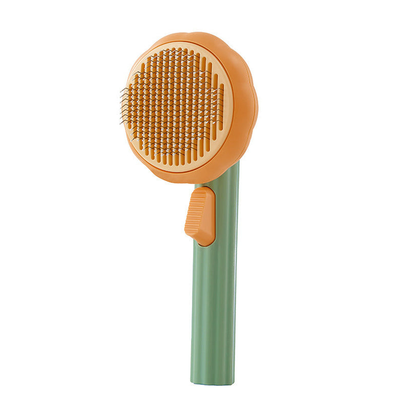 Hand-held steel wire self-cleaning comb for pet hair removal in pumpkin color.