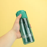 Portable pet water dispenser in green, ideal for outdoor travel with dogs and cats.