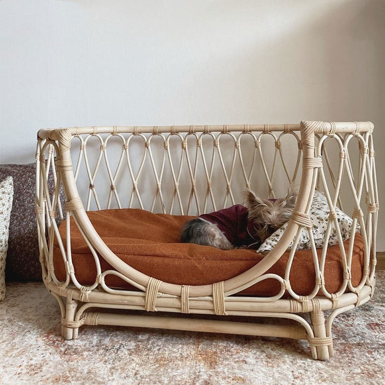 Handmade rattan woven pet bed for dogs with cushion.